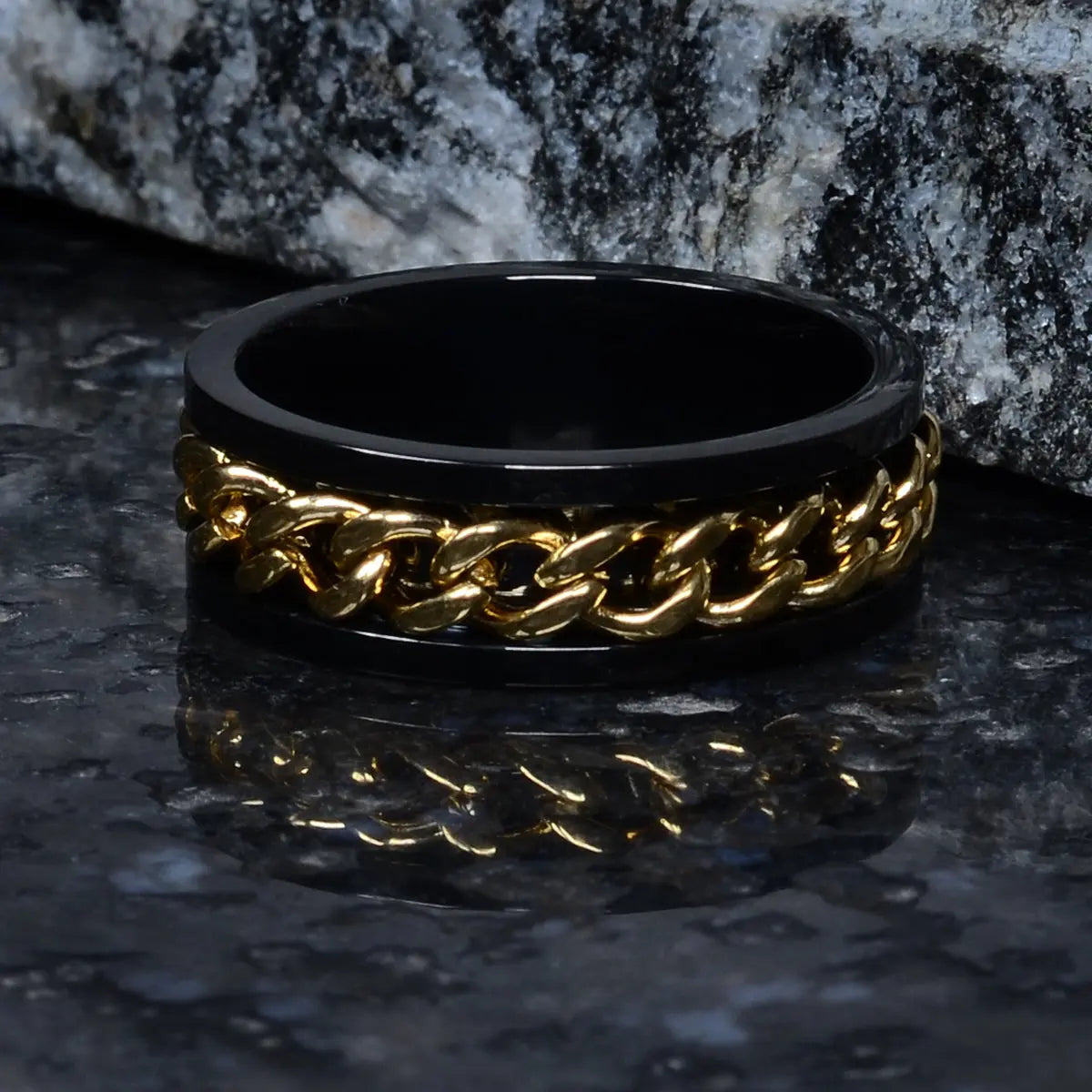 Black ring for men with gold chain design on a dark surface by Supreme Stud