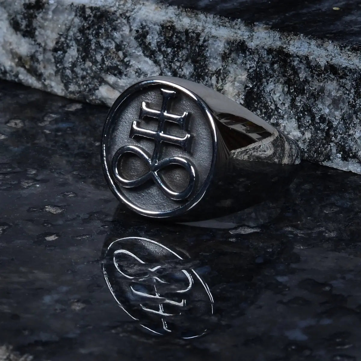 Steel ring for men with a symbol on a dark stone surface by Supreme Stud