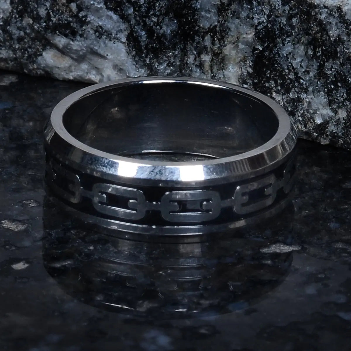 Steel ring for men with black pattern on a dark surface by Supreme Stud