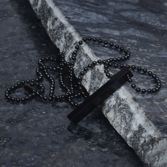 Black Steel Pendant for Men on a stone surface by Supreme Stud
