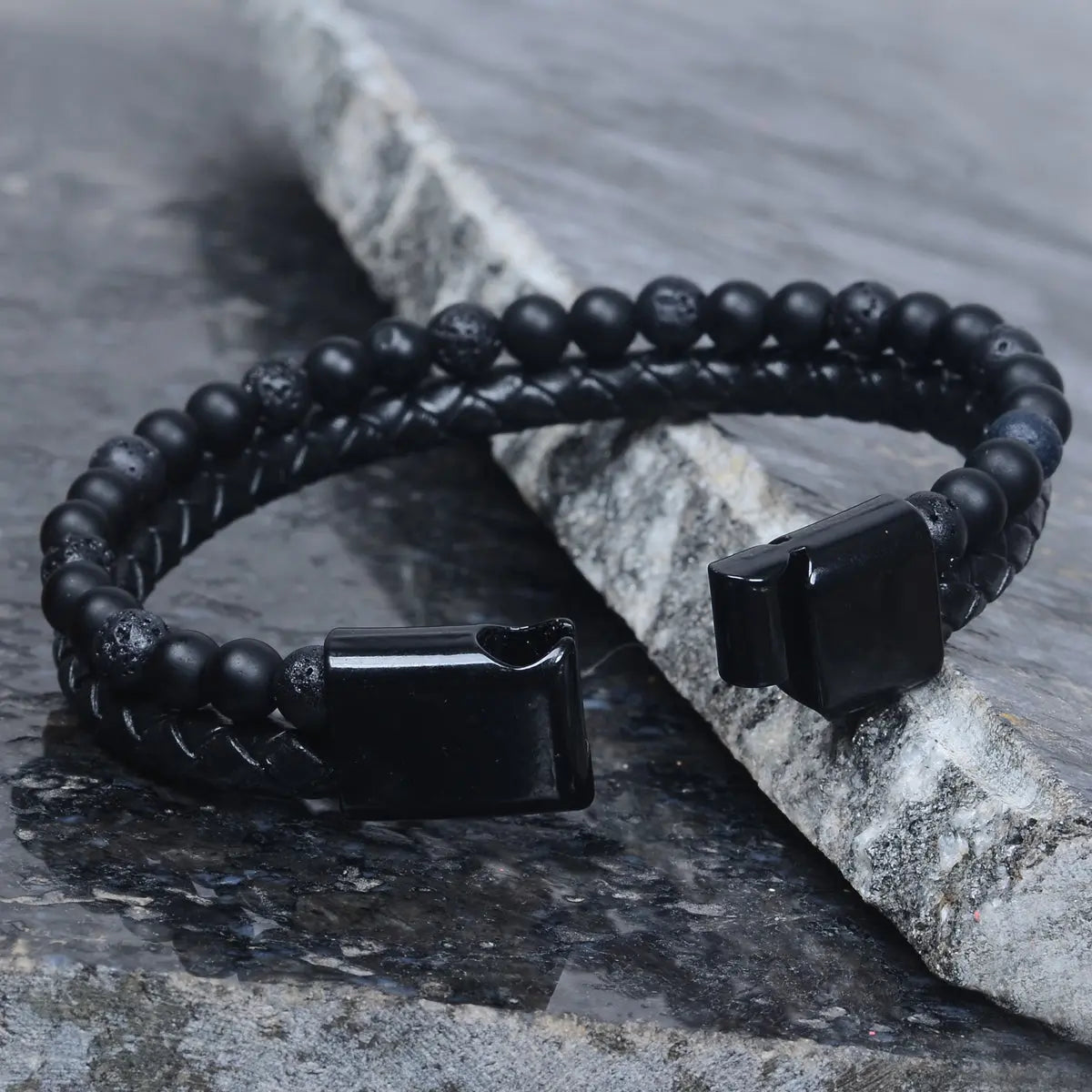 Black beaded leather bracelet for men with square black clasp on a stone surface by Supreme Stud