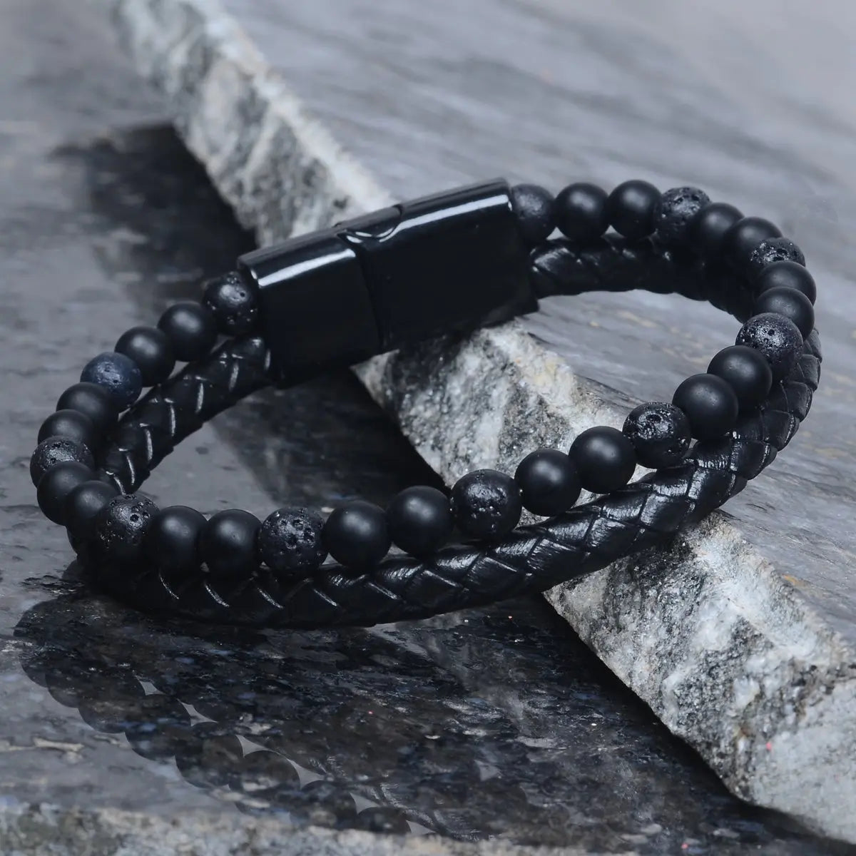 Black beaded leather bracelet for men on a stone surface by Supreme Stud