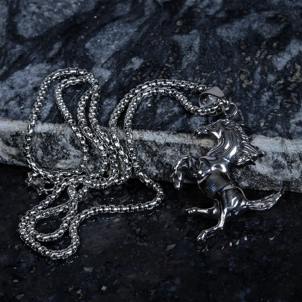 Steel chain for men with a horse pendant on a dark textured surface by Supreme Stud