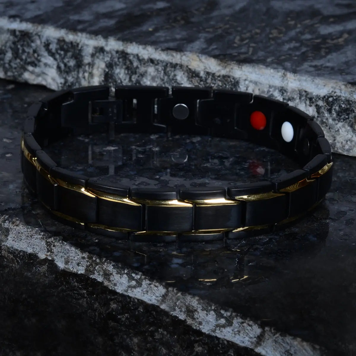 Black bracelet for men with gold accents on a dark stone surface by Supreme Stud