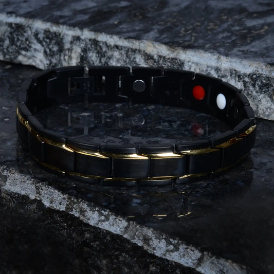 Black bracelet for men with gold accents on a dark stone surface by Supreme Stud