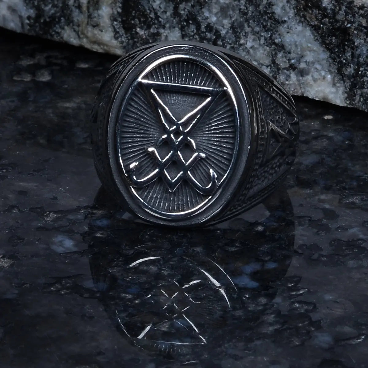 Steel Silver ring for men with a symbol on a dark reflective surface by Supreme Stud
