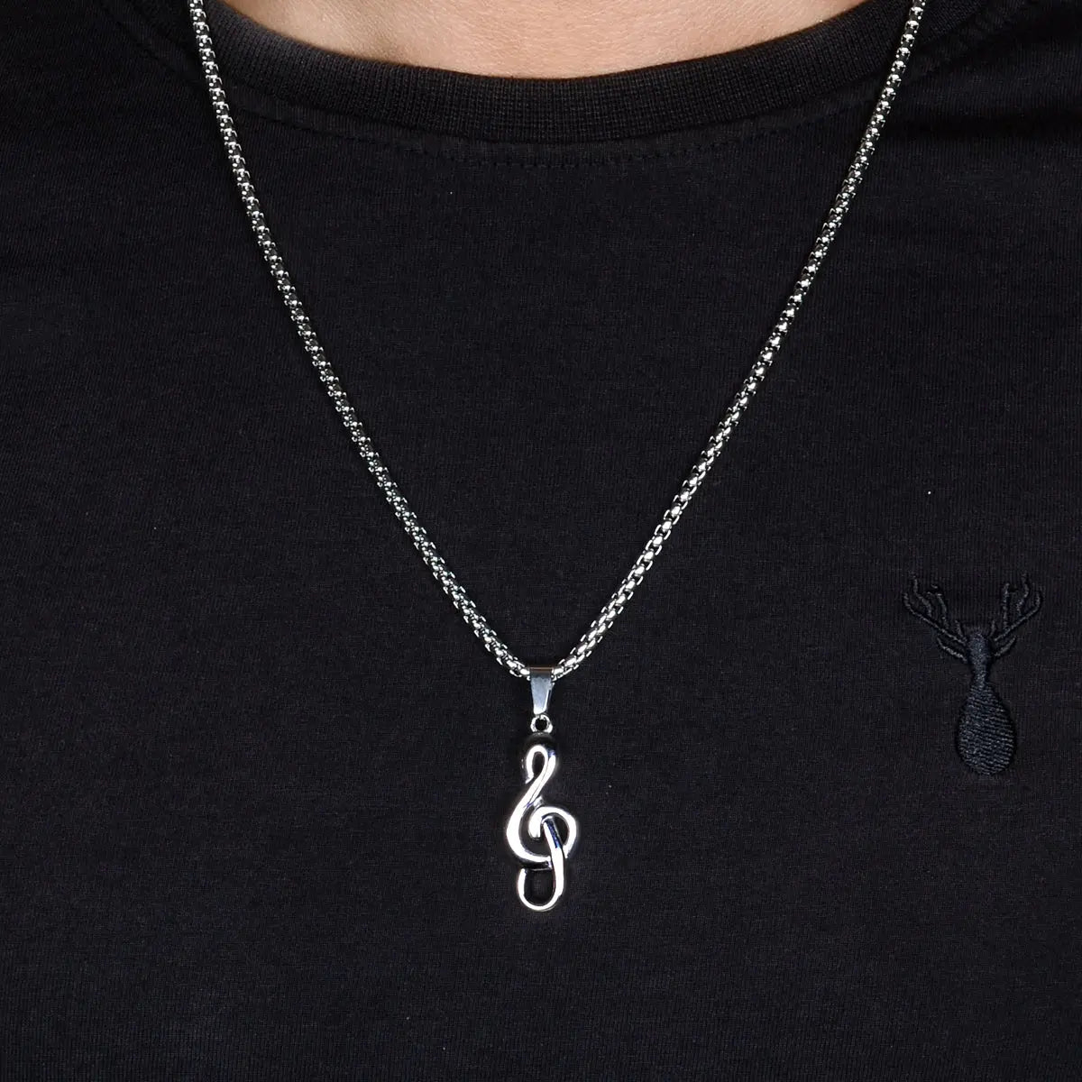 Steel necklace for men with a treble clef pendant on a black shirt by Supreme Stud