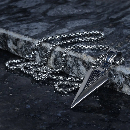 Silver necklace with a stainless steel pendant for men on a dark stone surface by Supreme Stud