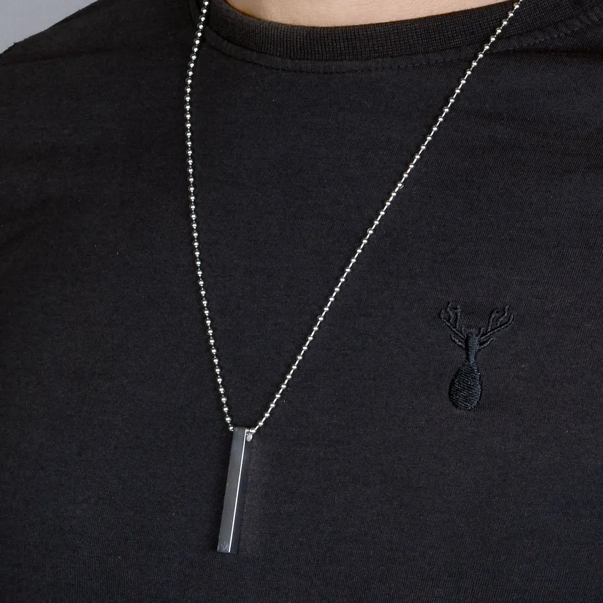 Steel pendant for men on black shirt by Supreme Stud