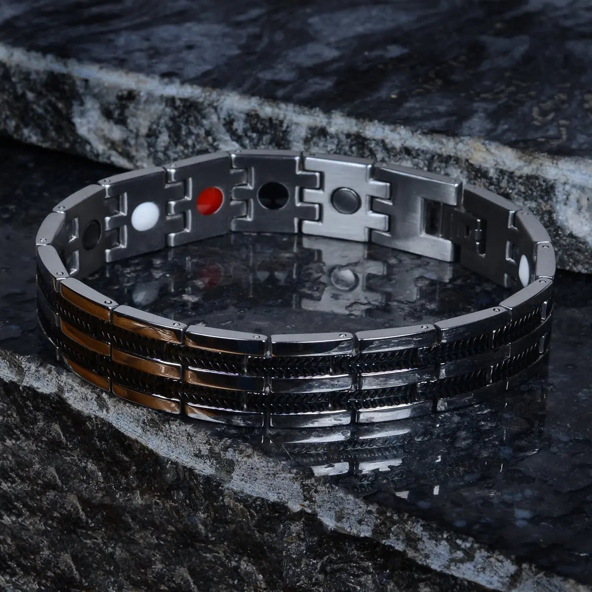 Metallic bio-magnetic bracelet for men with geometric design on a dark stone surface by Supreme Stud